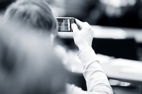 woman taking photos using her phone